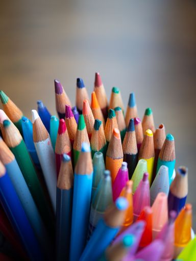 A vertical shot of a set of pencils on a blurry background
