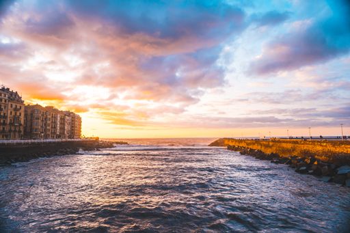 The beautiful sunset over the river and the sea in the city of San Sebastian, Gipuzkoa, Spain