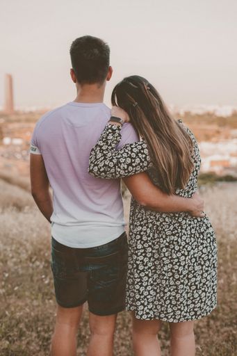 A back view of the young lovely hugging couple