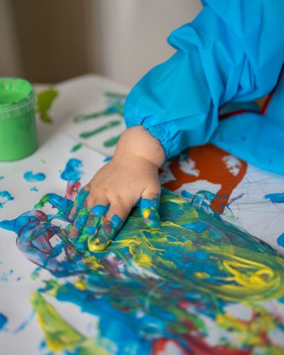 closeup photo of child playing with paint