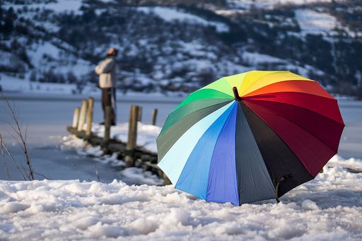 a colorful umbrella on a snowy day