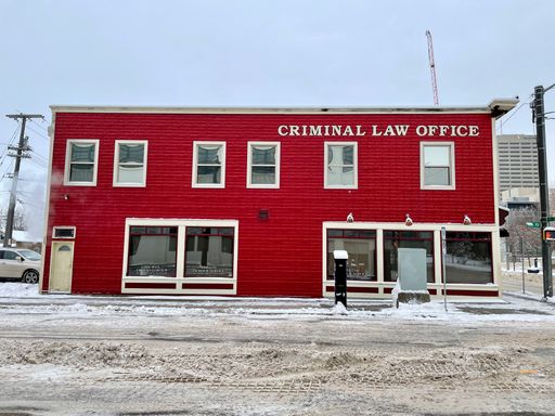 Historic Criminal Law Office building in downtown Edmonton with bright red exterior