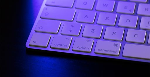 A closeup shot of a computer keyword  with a blue light on it