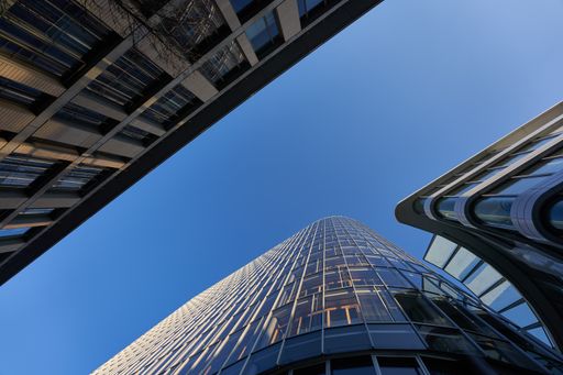 A low angle shot of modern buildings against a clear blue sky during the daytime