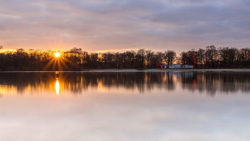 An evening view with reflections in the Silbersee, Germany, Lower Saxony, Hanover, Langenhagen