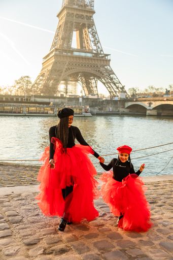 A vertical shot of a Black mother with her daughter in Paris, France