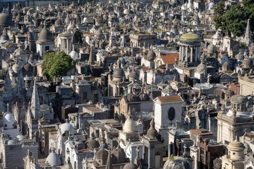 An aerial shot of the Recoleta cemetery surrounded by trees under the sunlight in Buenos Aires, Argentina