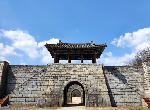 A big Korean gateway under a blue sky