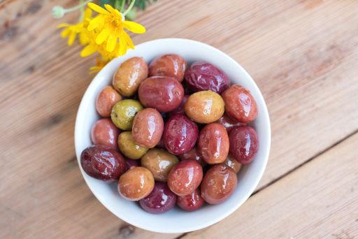 Agriculture - Closeup of freshly harvested table olives, Mediterranean diet, Delicious black, green and red olives with leaves from Greece