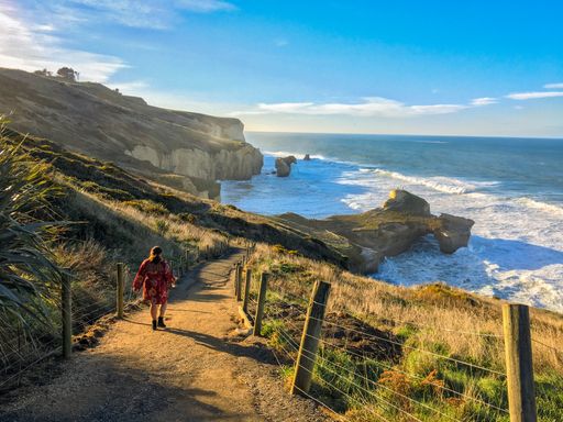 A woman walking to the beach in New Zealand