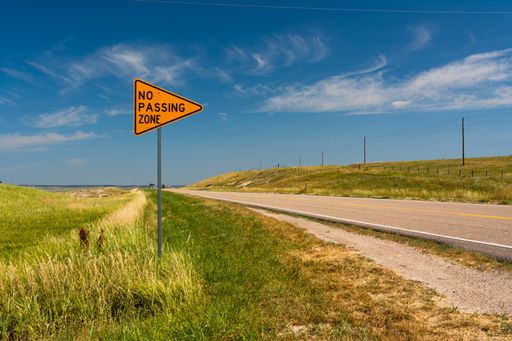 A road with "No Passing Zone" sign