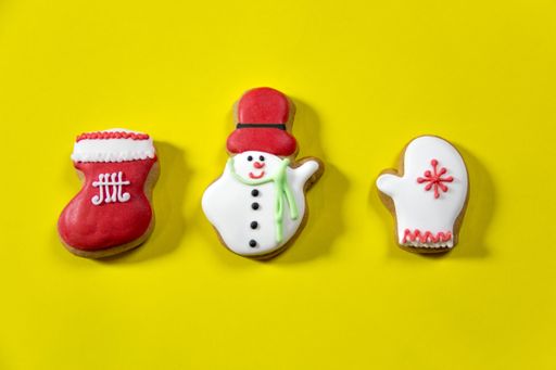 An isolated closeup shot of gingerbread Christmas cookies on a yellow background