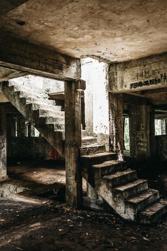 A vertical shot of stairs leading up in an abandoned building