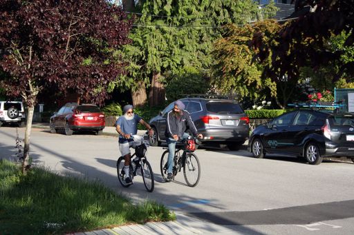 The Two Indian men riding bikes. Vancouver, British Columbia, Canada