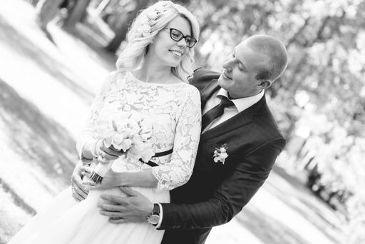 A beautiful shot of a newlywed couple posing for a photo in grayscale
