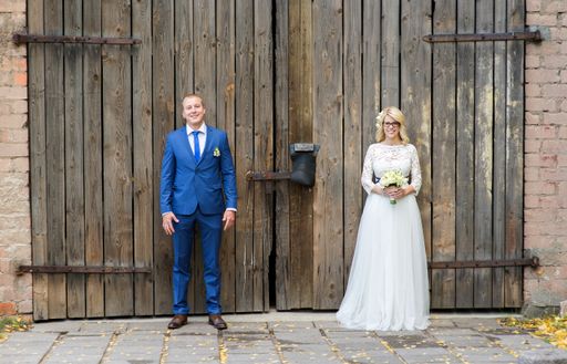 A beautiful shot of a newlywed couple posing for a photo