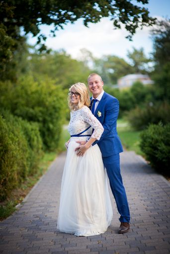 A beautiful shot of a newlywed couple posing for a photo