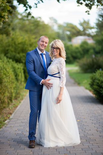 A beautiful shot of a newlywed couple posing for a photo