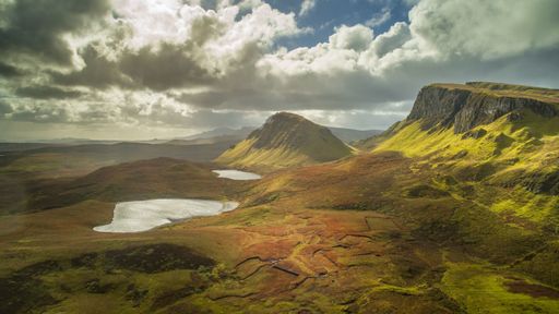 Grass covered cliffs at Quiraing. Scenic hiking spot, tourism destination. Amazing valley view, the Isle of Skye, Scotland.