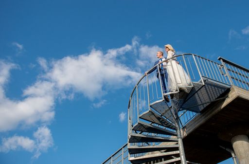 A beautiful shot of a newlywed couple posing for a photo
