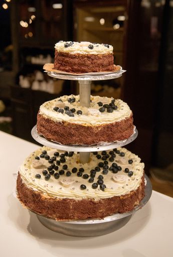 A vertical closeup shot of the wedding cake in the wedding hall