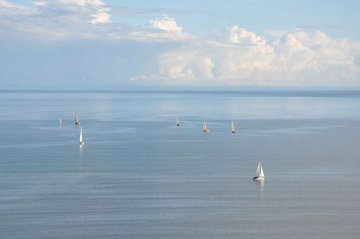 The sailing boats floating on the sea under a scenic cloudy sky captured in Swansea, Wales