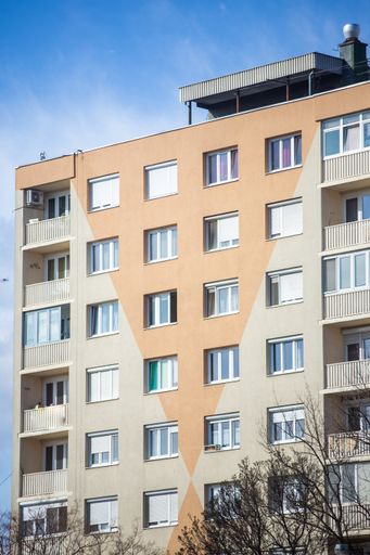 A beautiful view of a modern apartment building under the blue sky