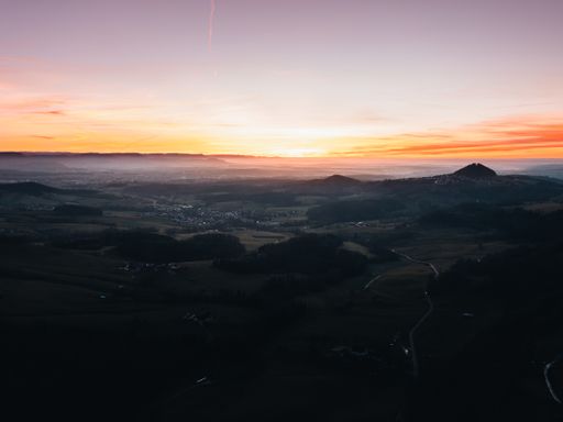 A panoramic view of the sunset over a beautiful view of nature