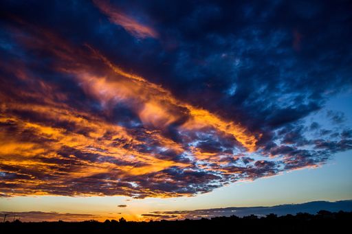 A low angle shot of the cloudy sky during sunset with thick clouds gathering