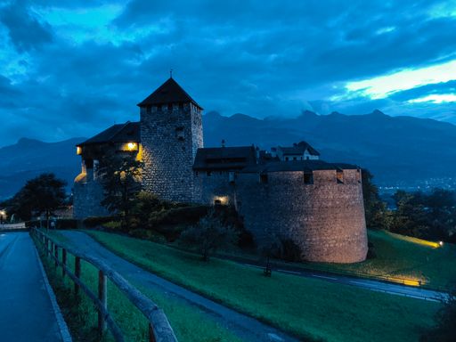 Old brick castle in Vaduz in night scenery with cloudy weather.