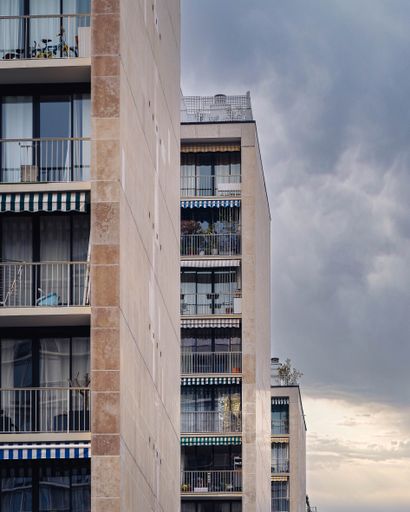 A vertical shot of beautiful residential buildings against a cloudy sky