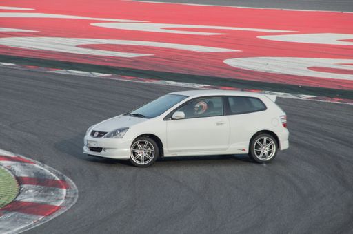 A white japan sports car Honda Civic Type-r model running in the track