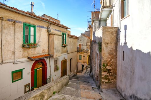 A narrow street among the old houses of a medieval town in the province of Salerno, in the Campania region.