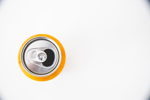 A top view of an open can of juice isolated on a white background
