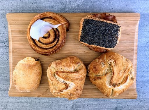 A high angle shot of some delicious homemade bread and cookies on a wooden surface