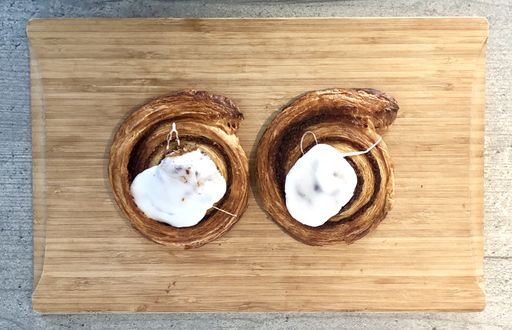 A high angle shot of a delicious homemade cookie with cream on a wooden surface