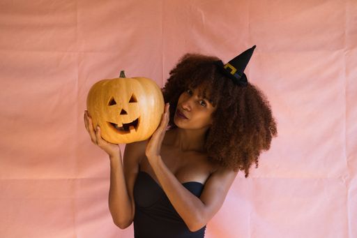 The young african american woman in witch costume for halloween party.
