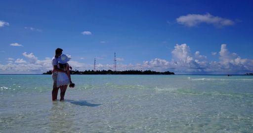A couple on the beach in Rasdhoo Atoll, Rasdhoo Island, The Maldives