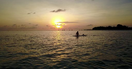 A couple on the beach in Rasdhoo Atoll, Rasdhoo Island, The Maldives at sunset