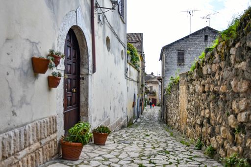 A narrow street among the old houses of a medieval town in the province of Caserta, in the Campania region.