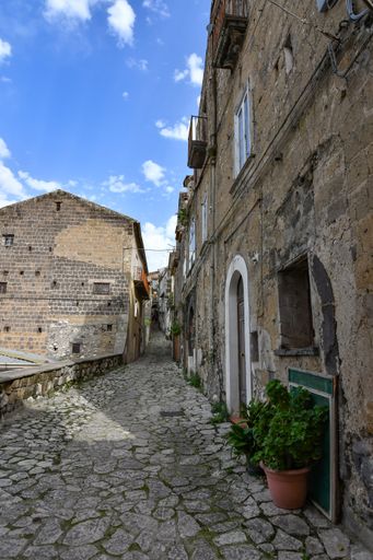 A narrow street among the old houses of a medieval town in the province of Caserta, in the Campania region.