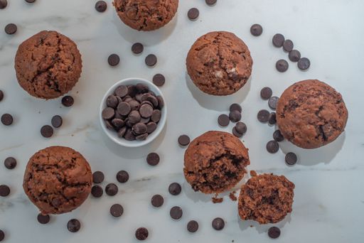 A top view of homemade chocolate muffins on a white surface