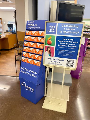 A vertical shot of iHealth COVID-19 Antigen Home Rapid Self-Test on display at pharmacy store entrance in the USA