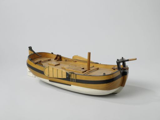 A closeup shot of a small vintage figurine of a ship isolated on a white background