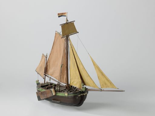 A closeup shot of a small vintage figurine of a ship isolated on a white background