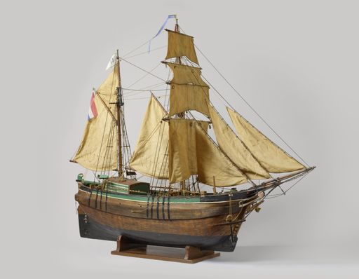 A closeup shot of a vintage figurine of a ship isolated on a white background