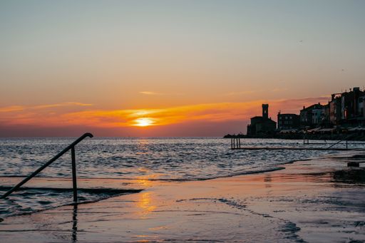 A beautiful shot of orange sunset over the coastal Piran town in Slovenia