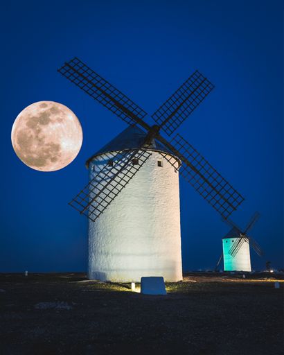 Campo de Criptana windmills, located in Ciudad Real, Castilla de Mancha, Spain. In the background a super moon.