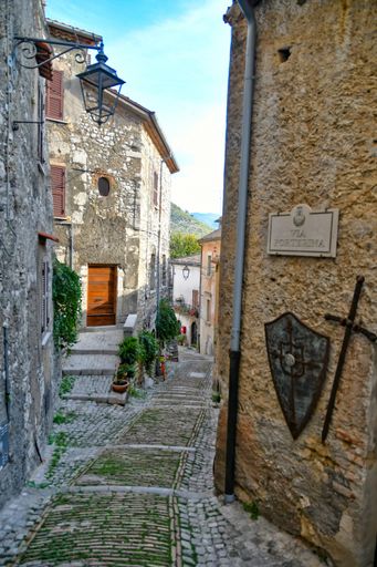 A narrow street among the old stone houses of Castro Dei Volsci, a medieval town in the Lazio region.