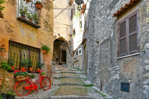 A narrow street among the old stone houses of Castro dei Volsci, a medieval town in Lazio region.